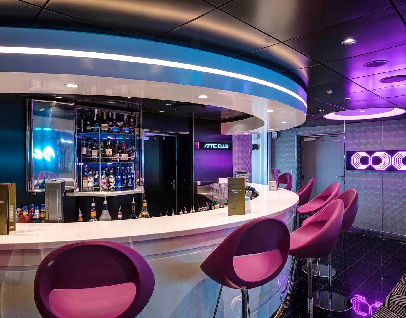 Modern bar with purple chairs and illuminated decor onboard an MSC cruise ship | MSC Cruises
